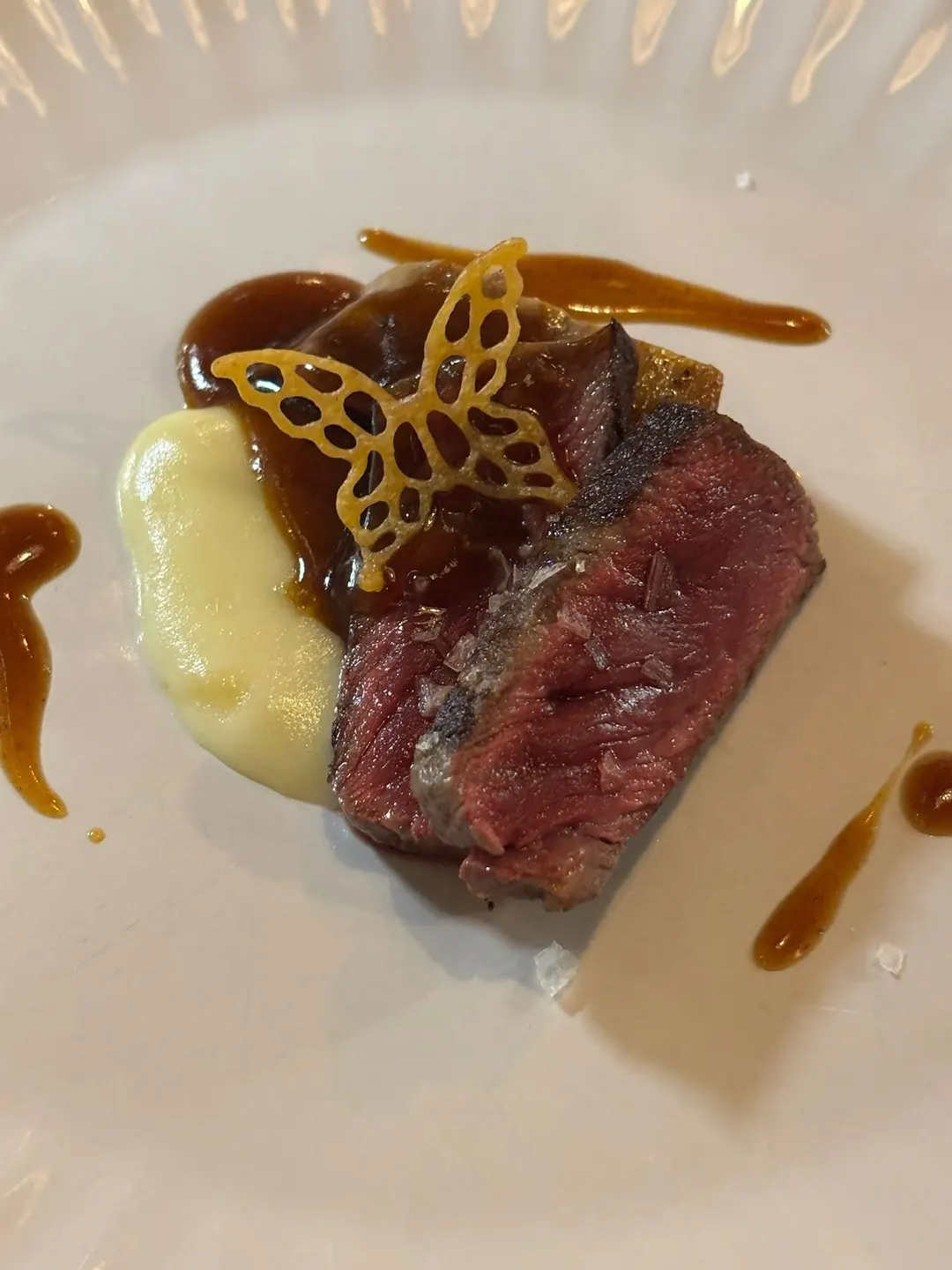 Seared beef with potato purée, a lacquered sauce and a crisp butterfly tuile