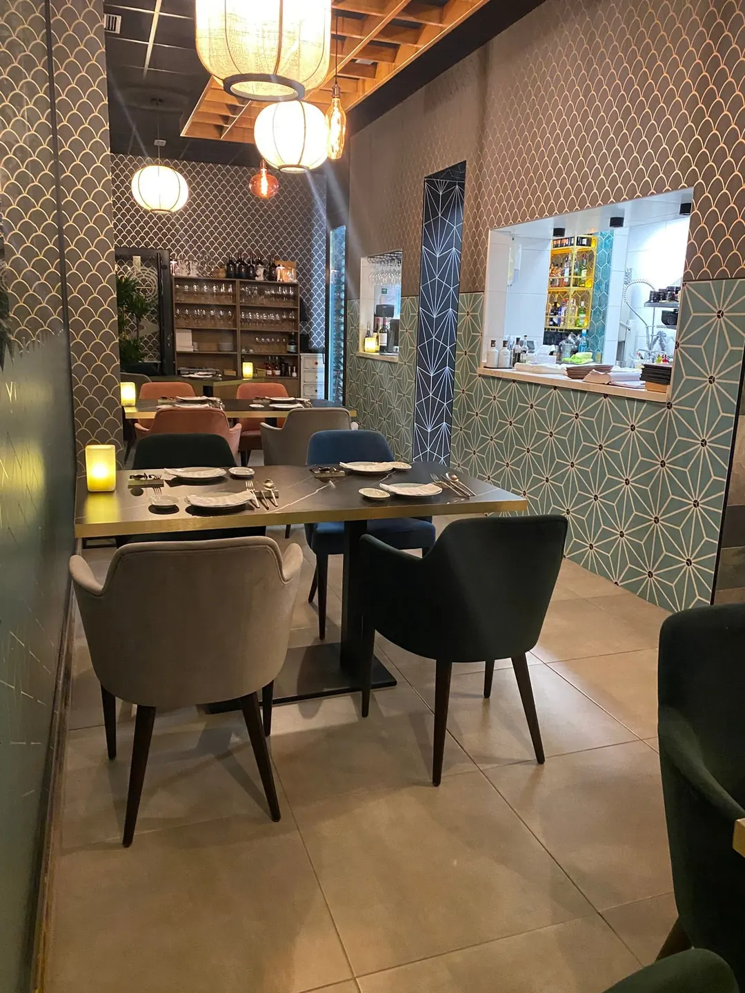 Kuvo's dining room: velvet chairs, paper lanterns and green star-patterned tile