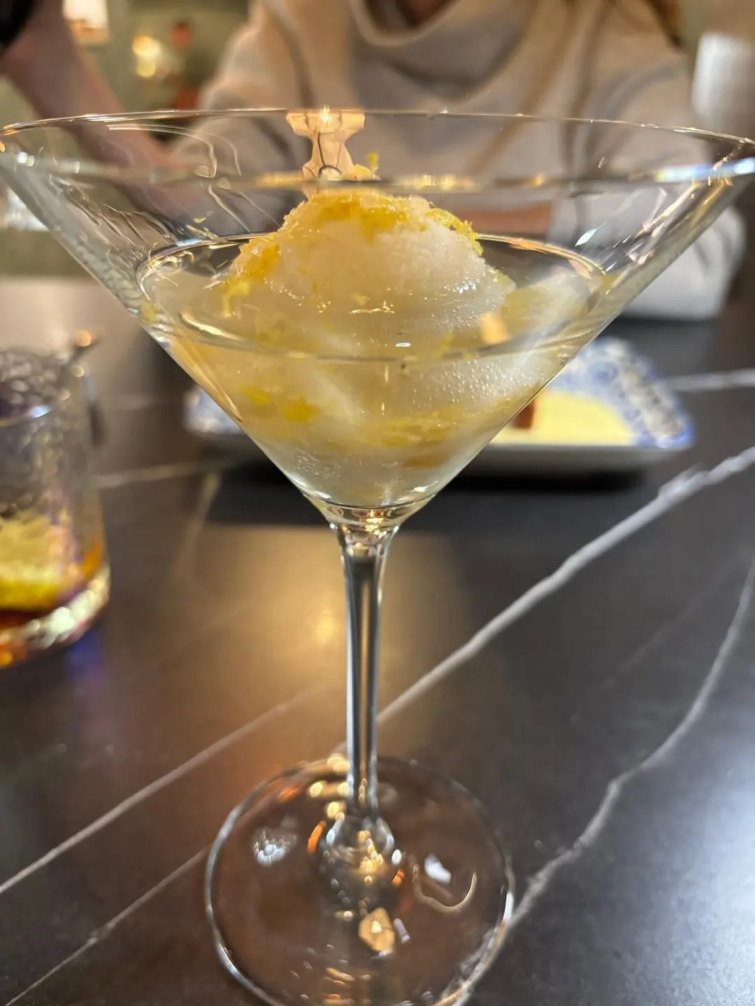 A coupe of lime sorbet scattered with zest