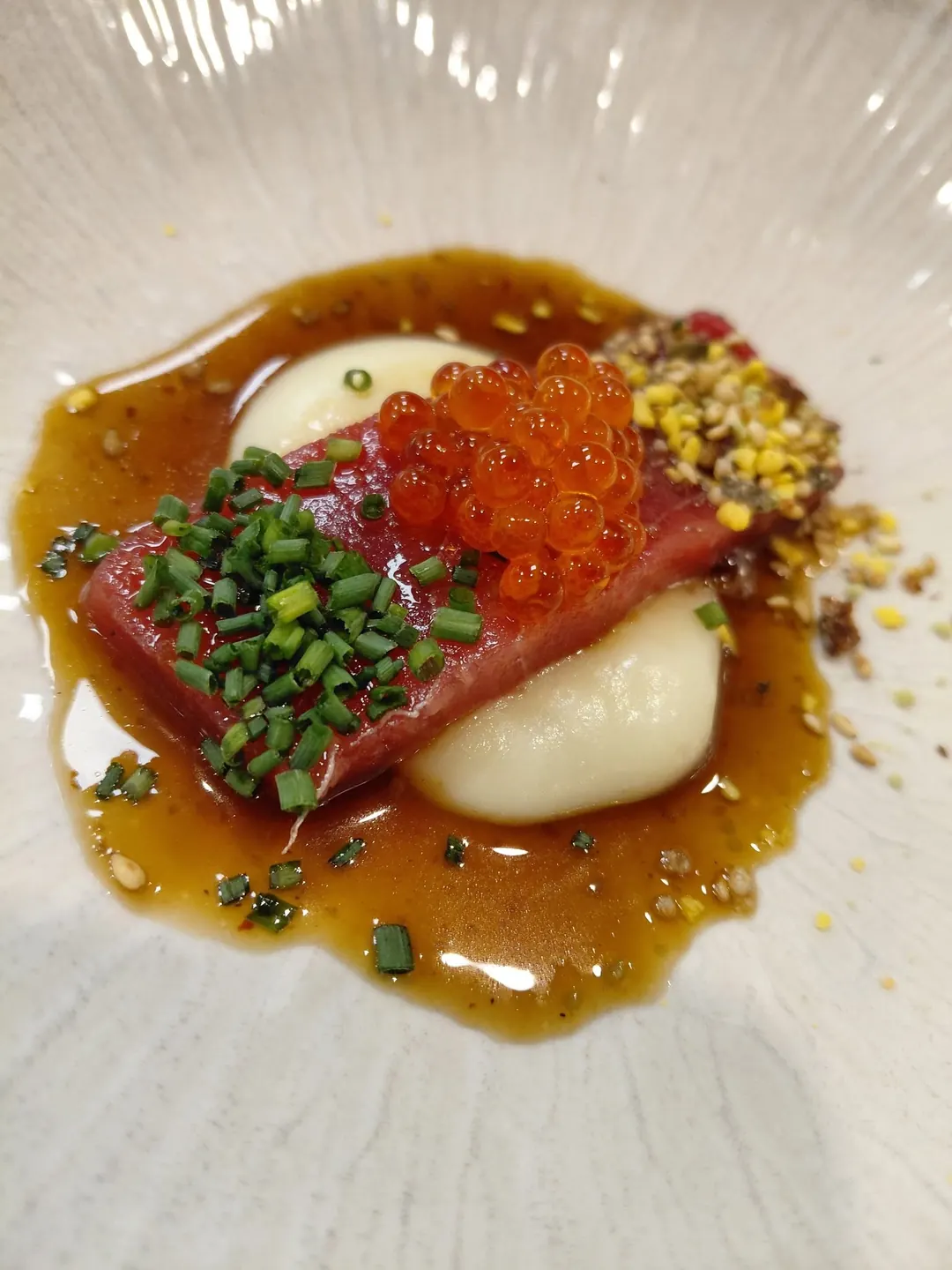 Red tuna with salmon roe, chives and toasted seeds in a glossy sauce